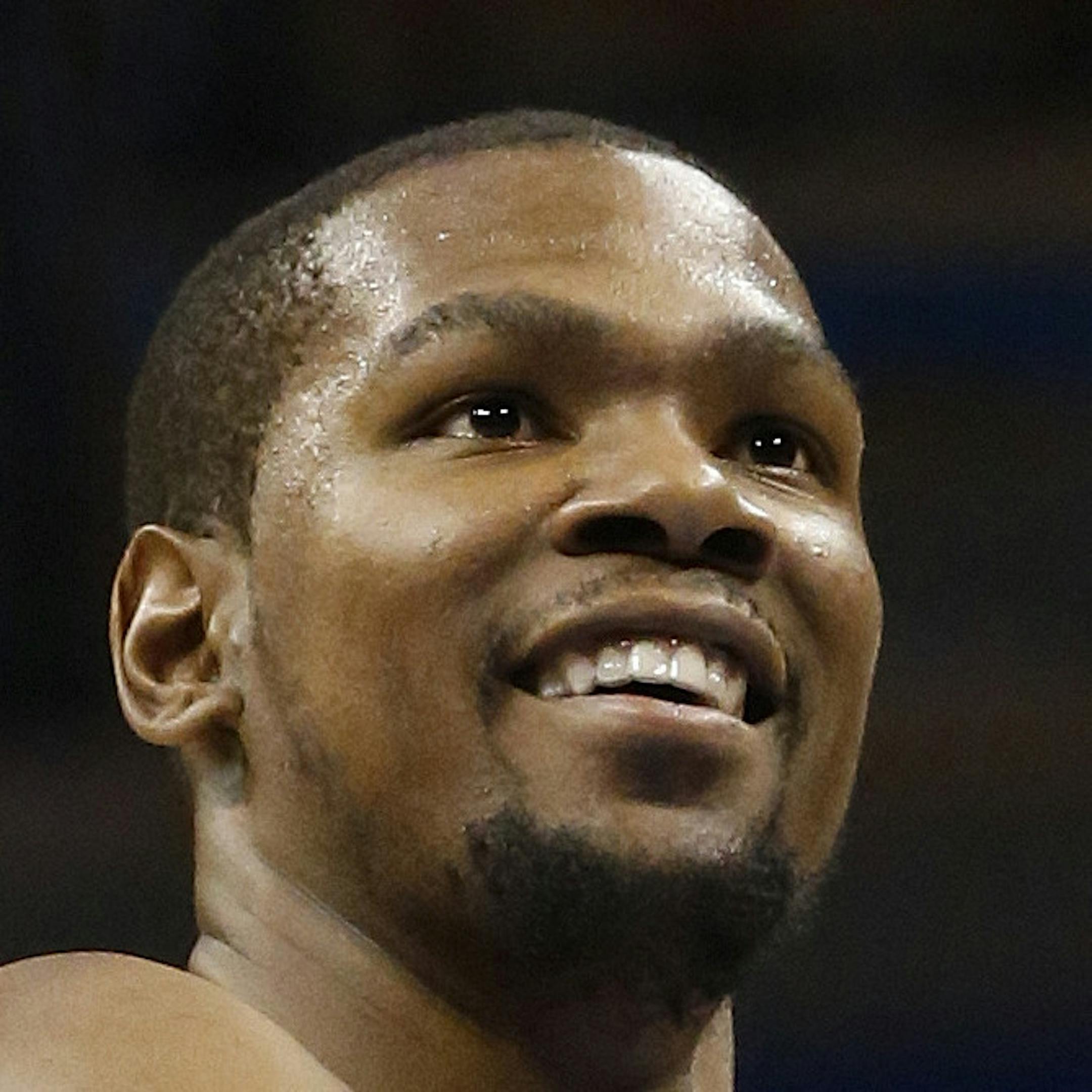 Oklahoma City Thunder forward Kevin Durant (35) smiles as shoots a foul shot during an NBA basketball game against the Washington Wizards in Oklahoma City, Wednesday, March 27, 2013. (AP Photo/Sue Ogrocki) ORG XMIT: MIN2013060517424589