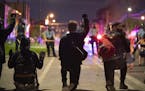 Demonstrators held their ground as Minneapolis Police sought to push them south on Minnehaha Ave. late Wednesday night. ] JEFF WHEELER • Jeff.Wheele