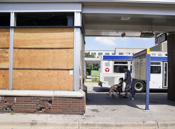 Windows broken out and boarded up following the killing of George Floyd and the unrest that ensued at the Transit Center on Chicago Avenue near Lake S