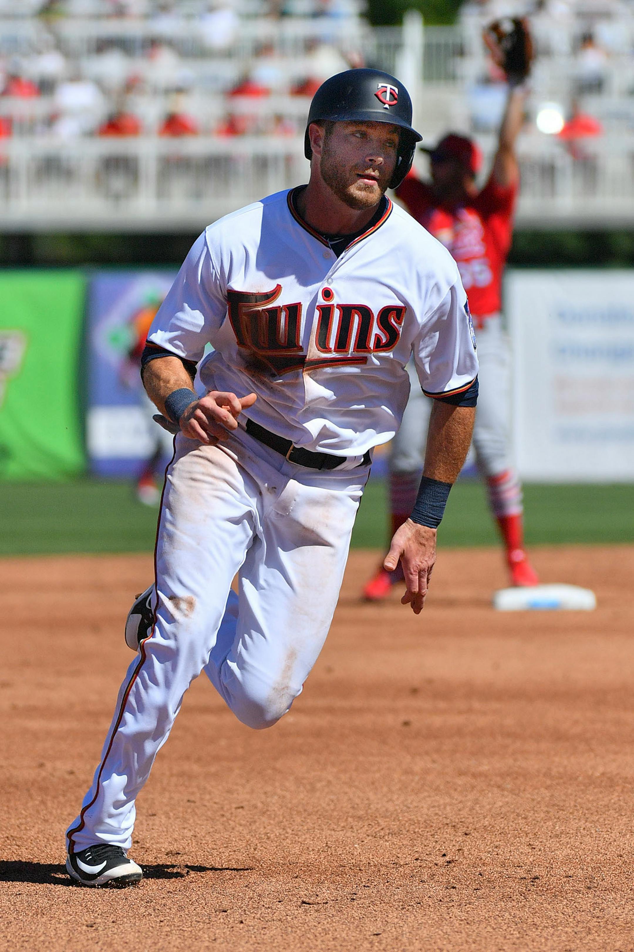 Twins infielder Taylor Featherston (38) scored off a double by Twins second baseman Brian Dozier (2) in the third inning.