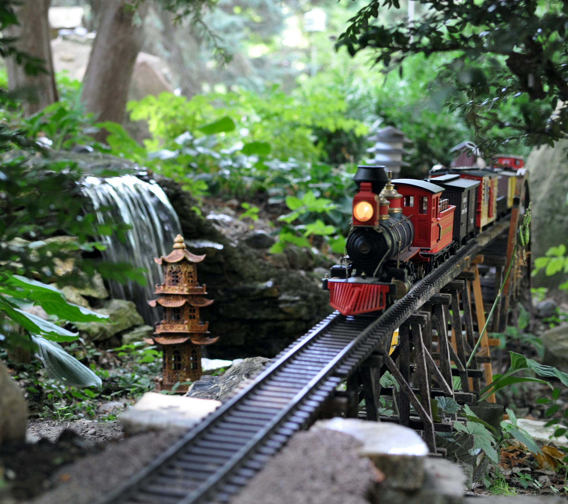 Photo by Liz Rolfsmeier Bud Lutz's G-scale train passes by waterfalls and over miniature truss bridges he builds himself.