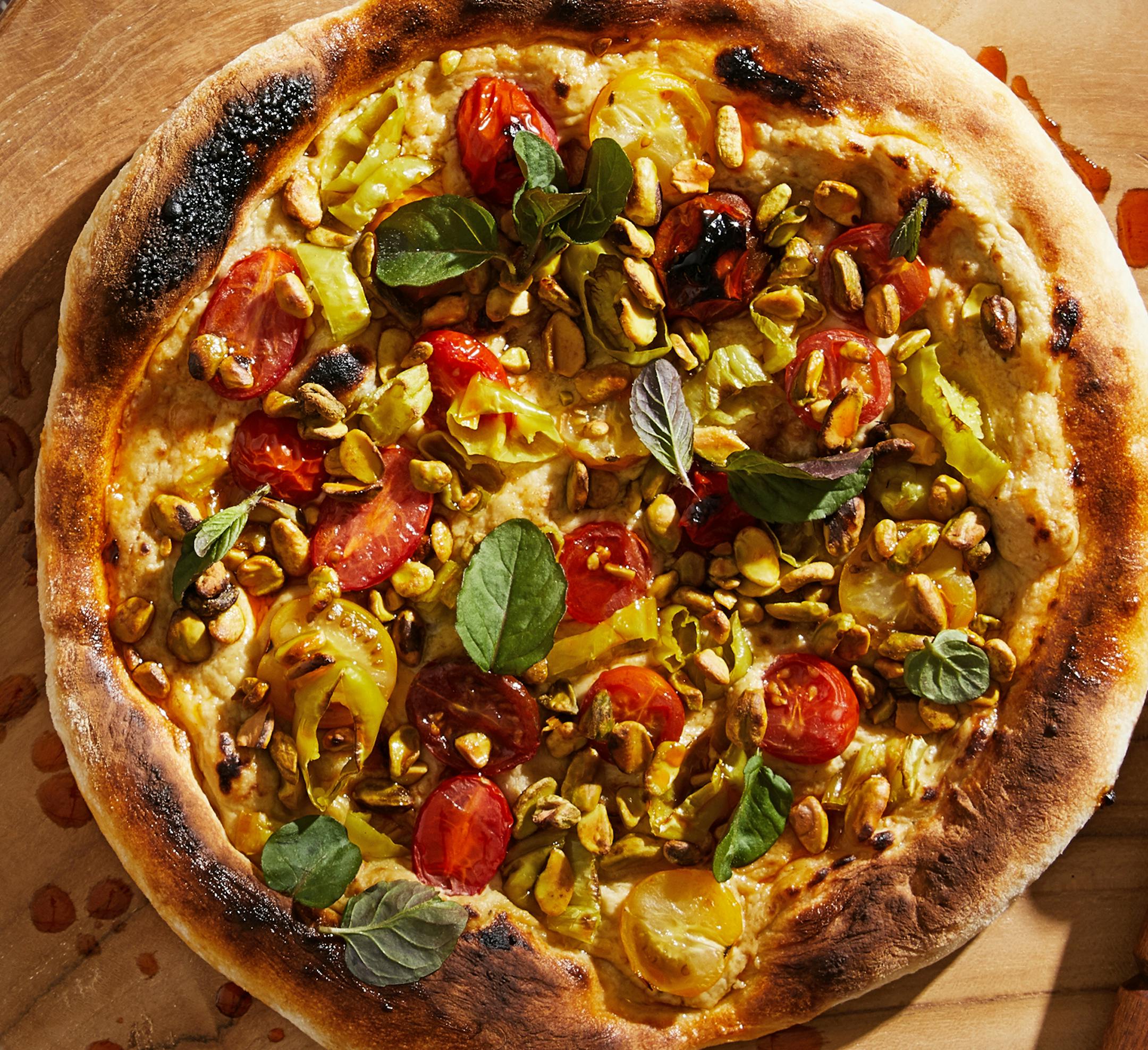 Baba Ghanouj Pizza With Pepperoncini, Mint and Chile Oil. MUST CREDIT: Photo by Tom McCorkle for The Washington Post; food styling by Lisa Cherkasky for The Washington Post.