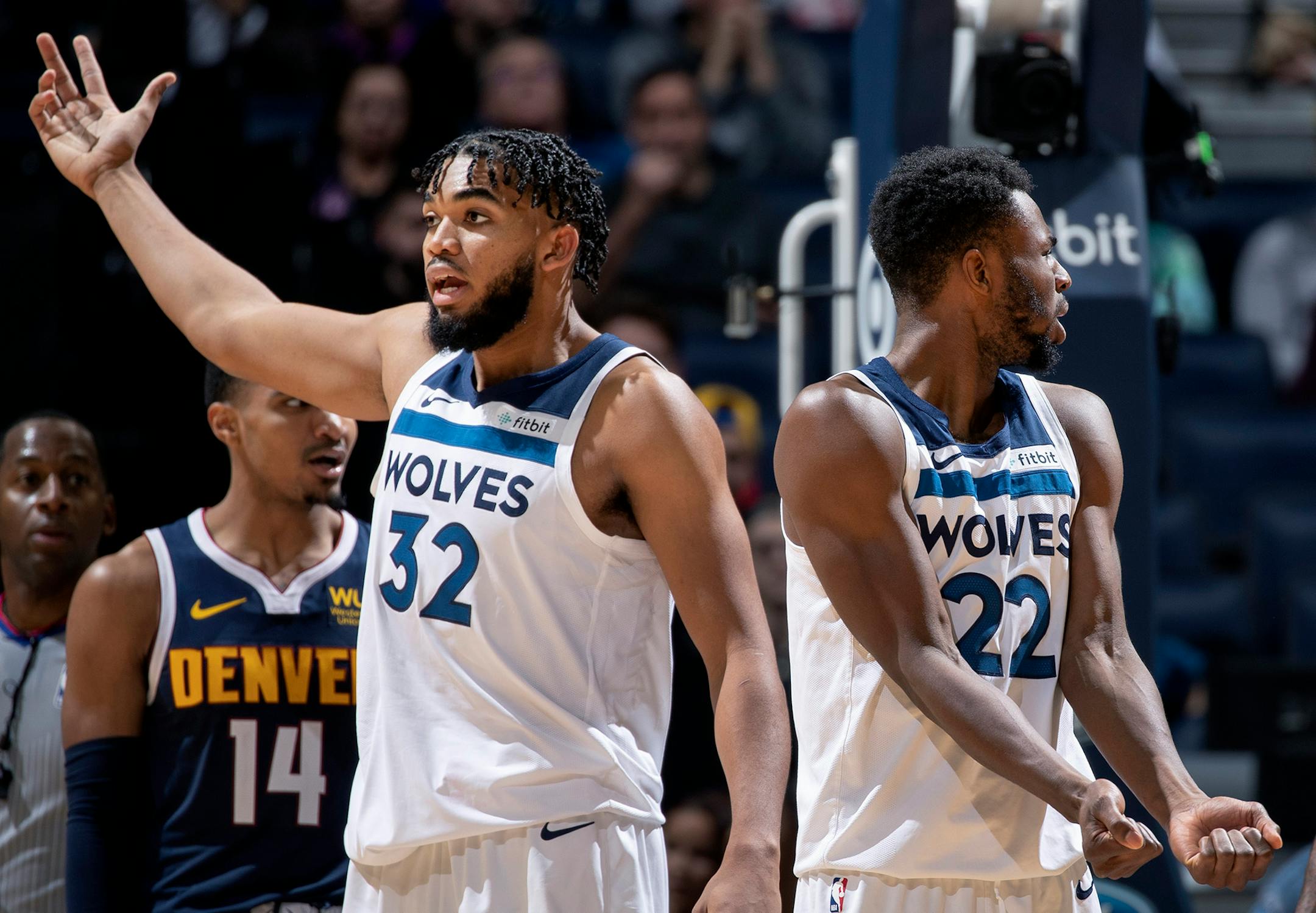 Karl-Anthony Towns (32) and Andrew Wiggins (22) of the Timberwolves question a call in the fourth quarter against the Nuggets on Nov. 10