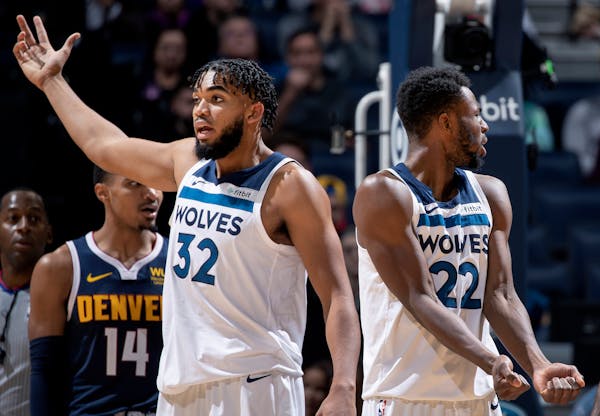 Karl-Anthony Towns (32) and Andrew Wiggins (22) of the Timberwolves question a call in the fourth quarter against the Nuggets on Nov. 10