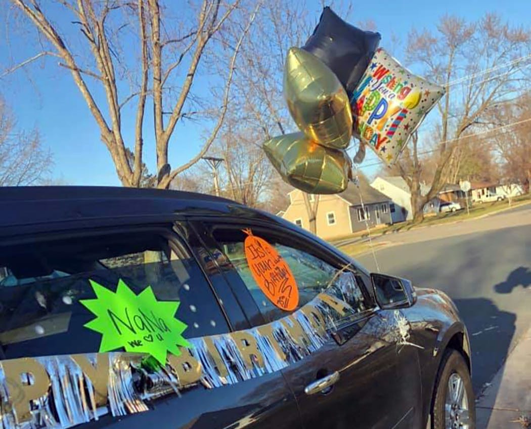 About 20 cars, many decorated with balloons and posters, lined up on March 30 to wish Bernie Schluessler a happy 75th birthday 