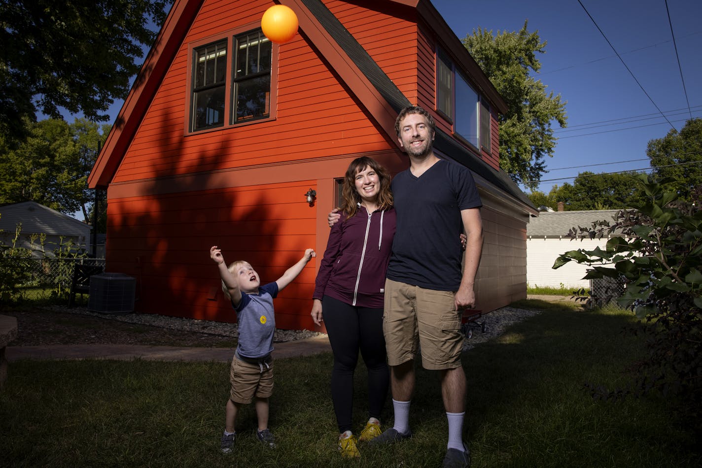 Stephanie Erickson Ross Pfund and son Quin Pfund, 2, photographed in front of their Accessory Dwelling Unit in Minneapolis. ] CARLOS GONZALEZ • cgonzalez@startribune.com – Minneapolis, MN – September 2, 2020, Home of the Month - bold little ADU on the alley expanded a young Minneapolis couple's living space