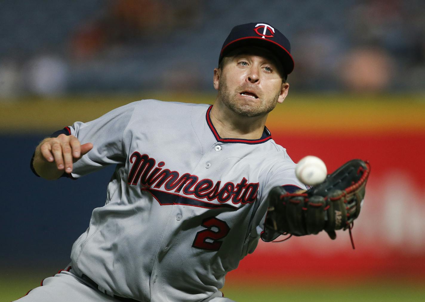 Minnesota Twins second baseman Brian Dozier makes the catch on a pop fly by Atlanta Braves' Adonis Garcia during the seventh inning of a baseball game in Atlanta, Tuesday, Aug. 16, 2016. (AP Photo/John Bazemore)