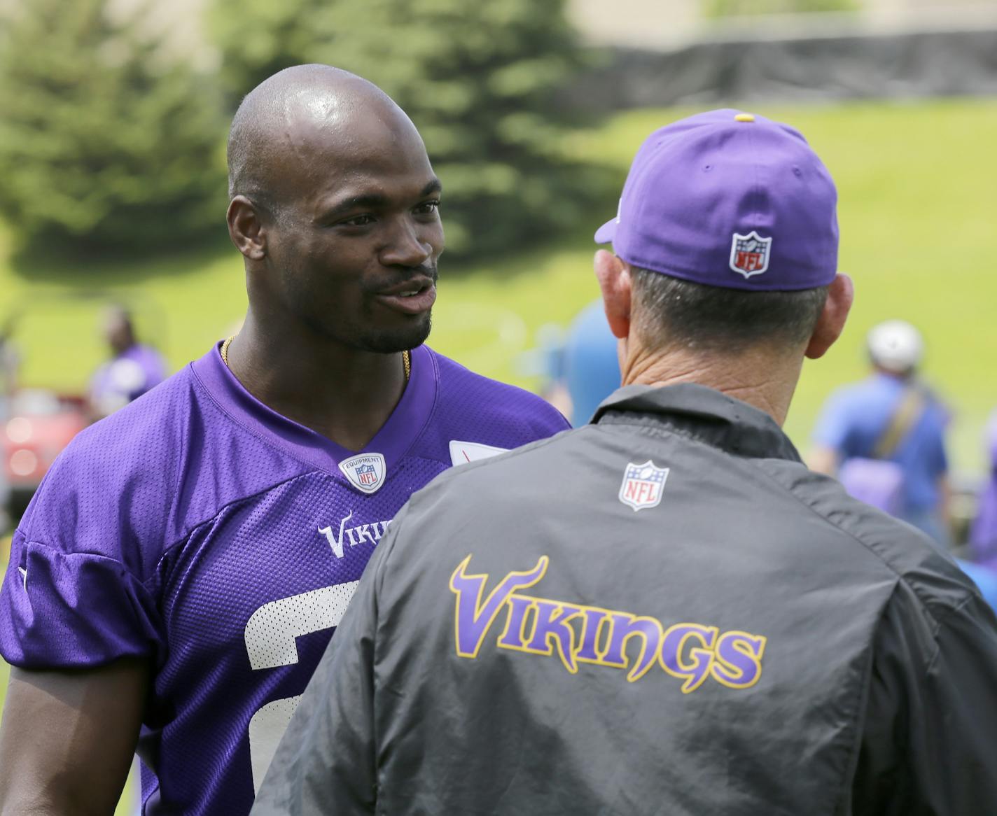 Minnesota Vikings running back Adrian Peterson, left, talks with head coach Mike Zimmer, right, during NFL football minicamp in Eden Prairie, Minn., Thursday, June 18, 2015. (AP Photo/Ann Heisenfelt) ORG XMIT: MIN2015071818432444