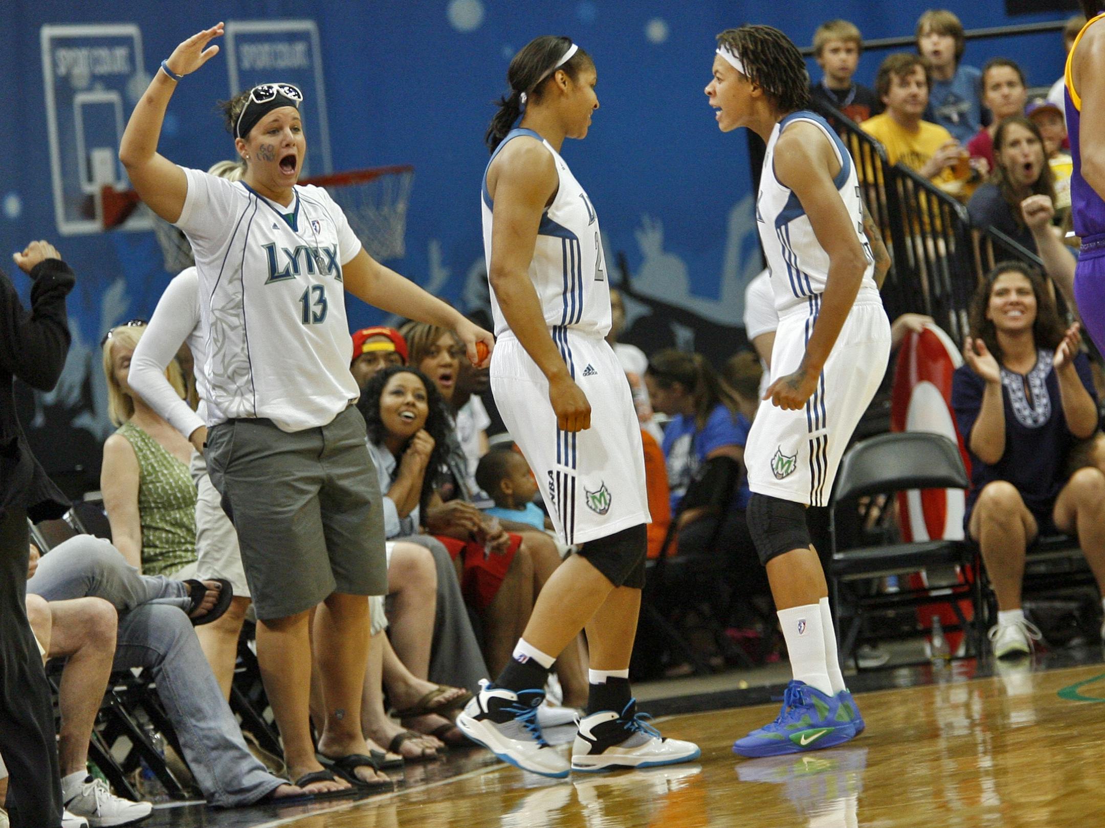 Lynx fans and Lynx player Seimone Augustus, right loved Maya Moore's (center) block of a Sparks three-point attempt in first half action.