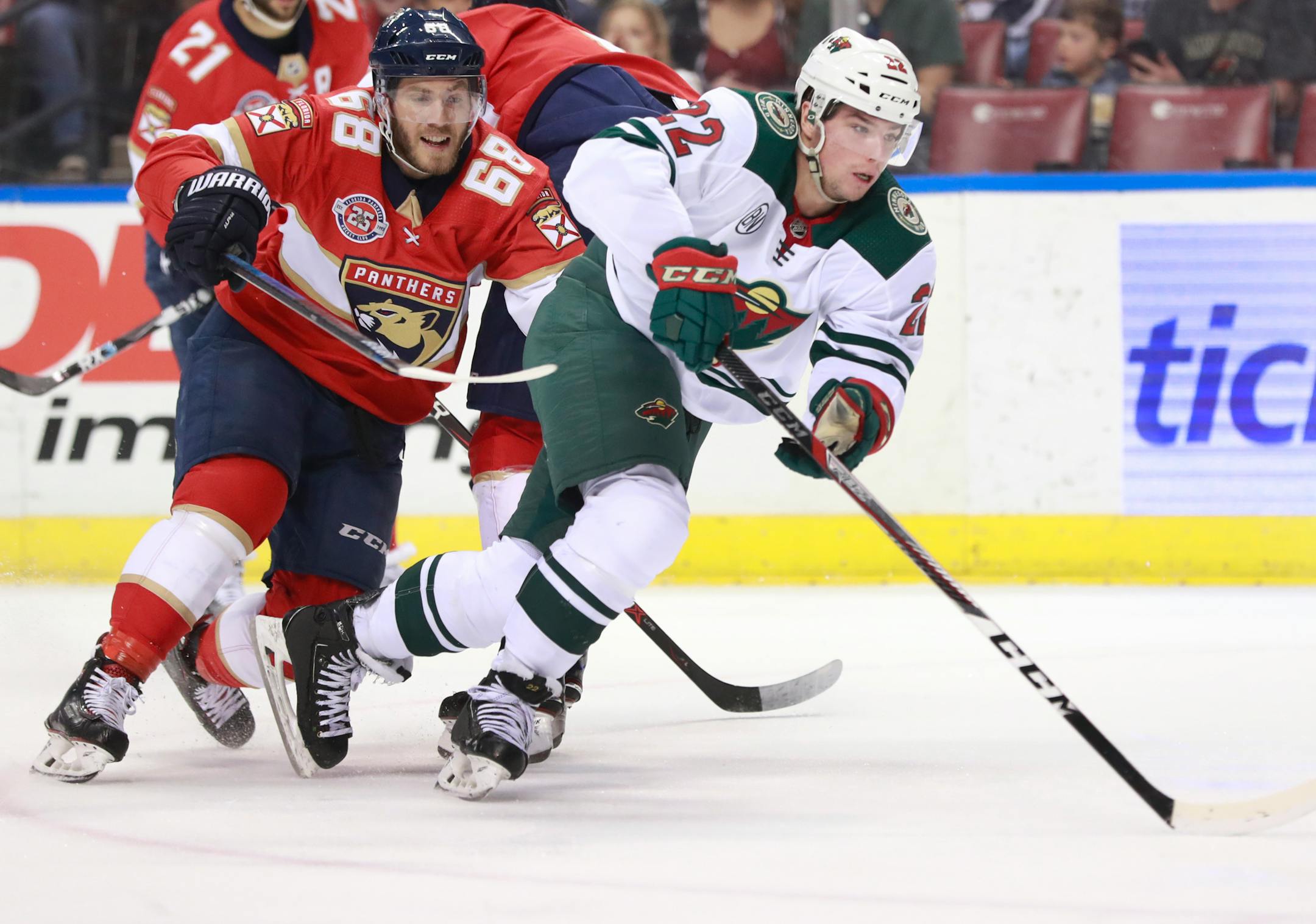 Florida Panthers left wing Mike Hoffman (68) and Minnesota Wild left wing Kevin Fiala (22) battle for the puck during the first period of an NHL hockey game, Friday, March 8, 2019 in Sunrise, Fla. (AP Photo/Wilfredo Lee)