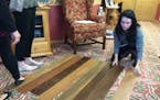 Hayley Hill, an interior design student at Century College, lays out flooring samples for approval. Hill and other students are redesigning a suite at