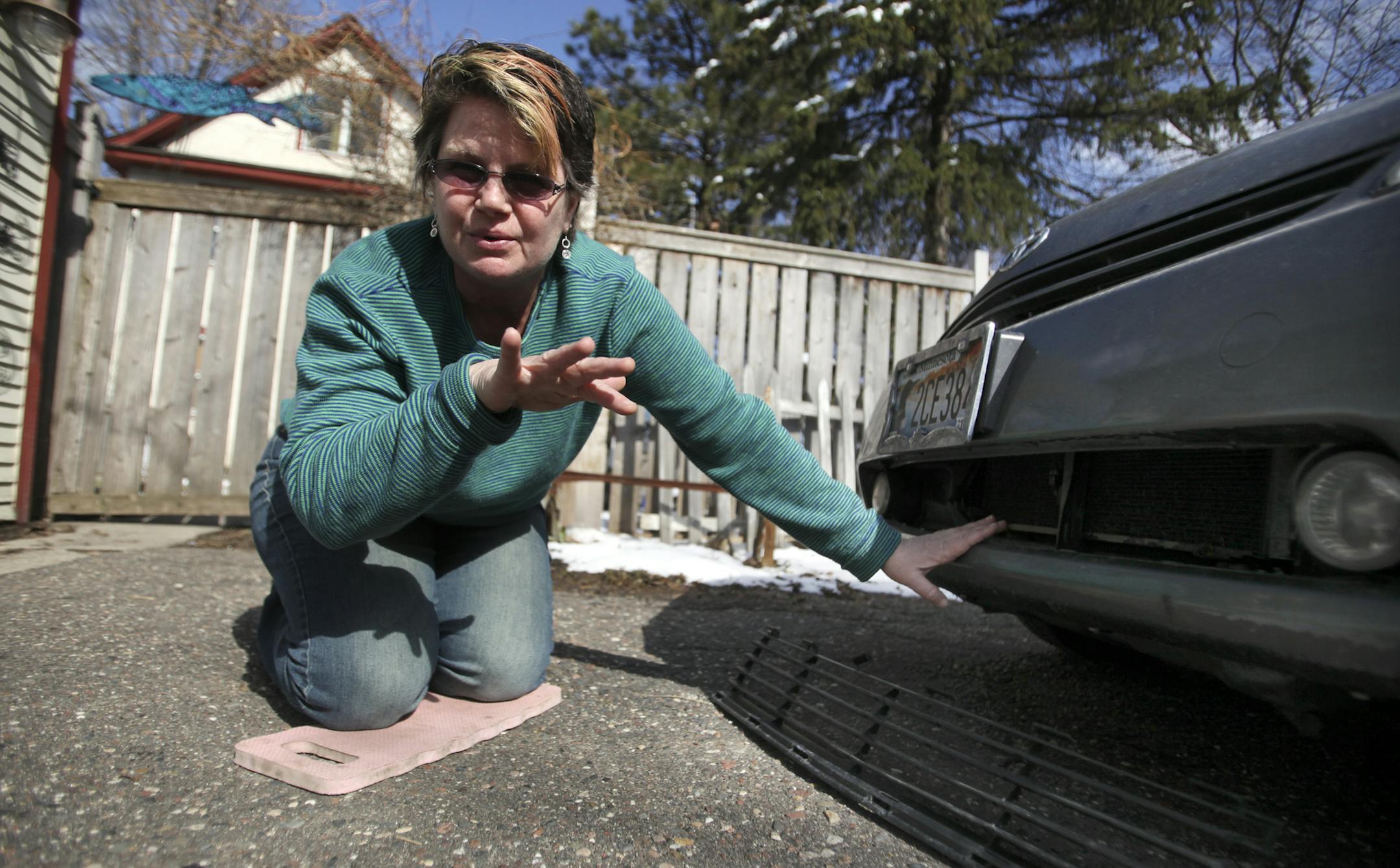 Sarah Dietrich of Minneapolis was driving on W. River Parkway near Franklin Ave. last Thursday morning when she hit a pothole that was so jarring that the grill on her 2004 Toyota Prius flew off, the fog lights quit working and the car's front is out of alignment causing the entire front end to shake while driving. Dietrich will be bringing it into the shop to get the damages assessed and she was photographed outside her residence Tuesday, April 23, 2013, in Minneapolis, MN.](DAVID JOLES/STARTRI