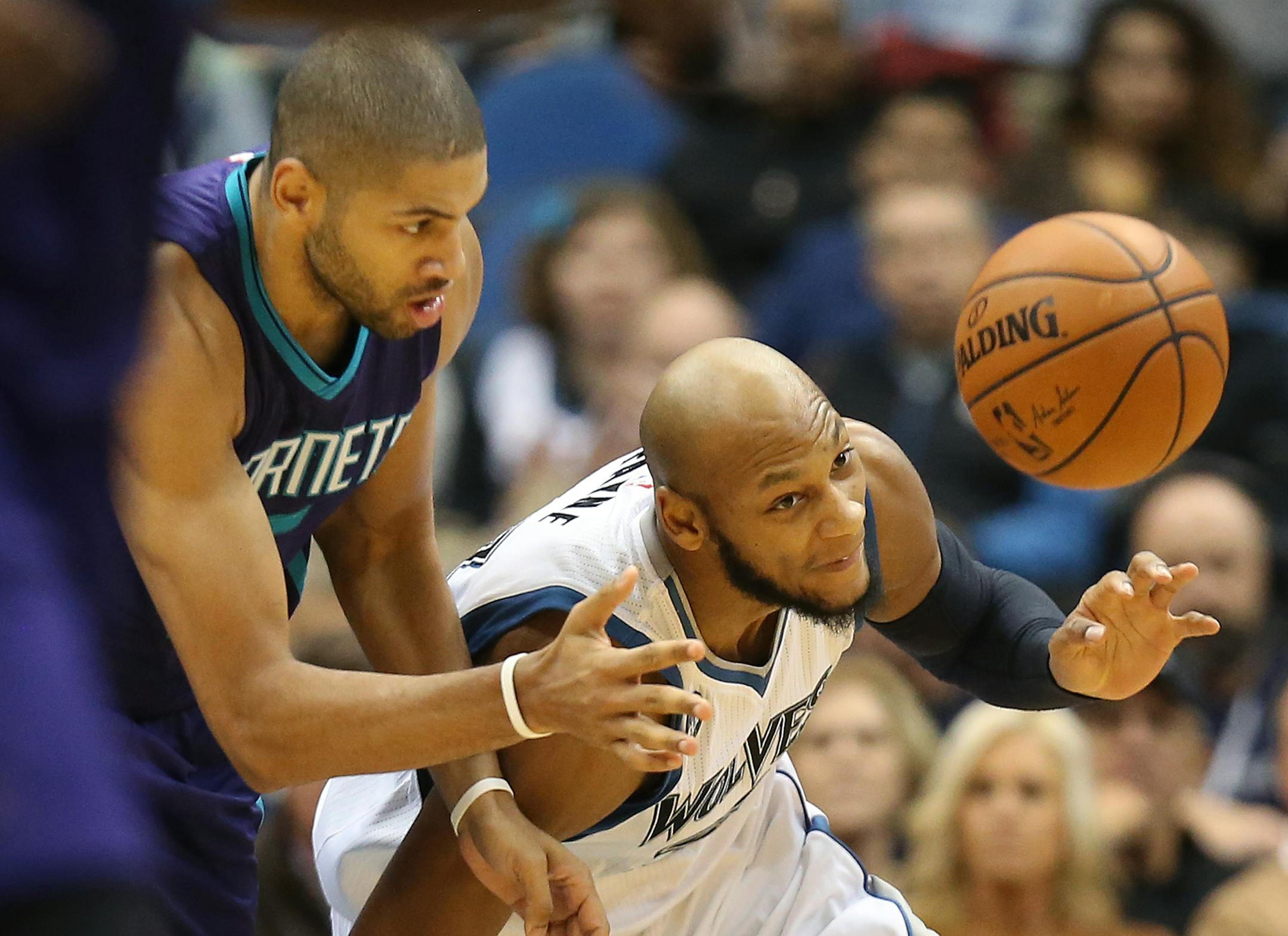 Minnesota Timberwolves forward Adreian Payne (33) and Charlotte Hornets forward Nicolas Batum (5) reached for a loose ball at Target Center Tuesday November 10, 2015 in Minneapolis.