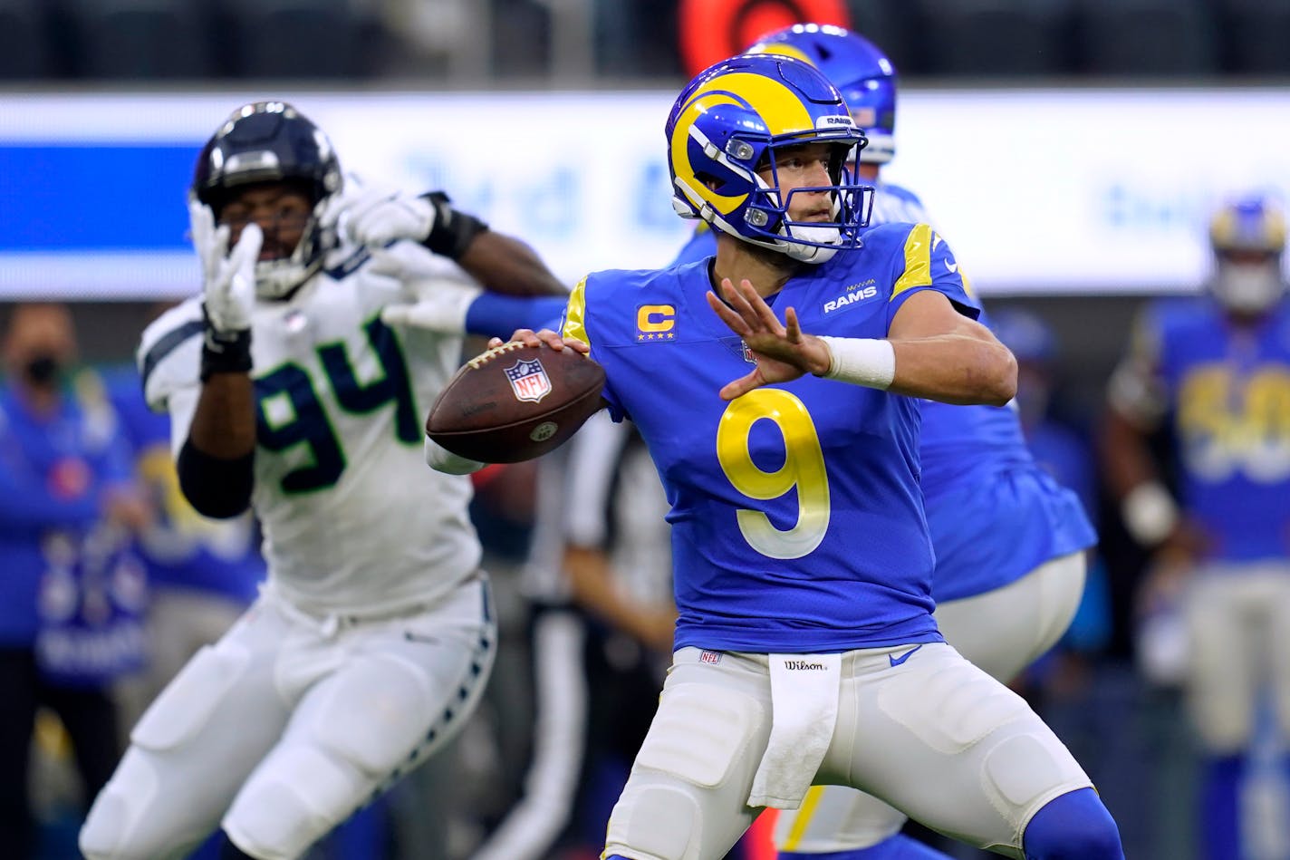 Los Angeles Rams quarterback Matthew Stafford looks for a receiver during the first half of the team's NFL football game against the Seattle Seahawks on Tuesday, Dec. 21, 2021, in Inglewood, Calif. (AP Photo/Ashley Landis)