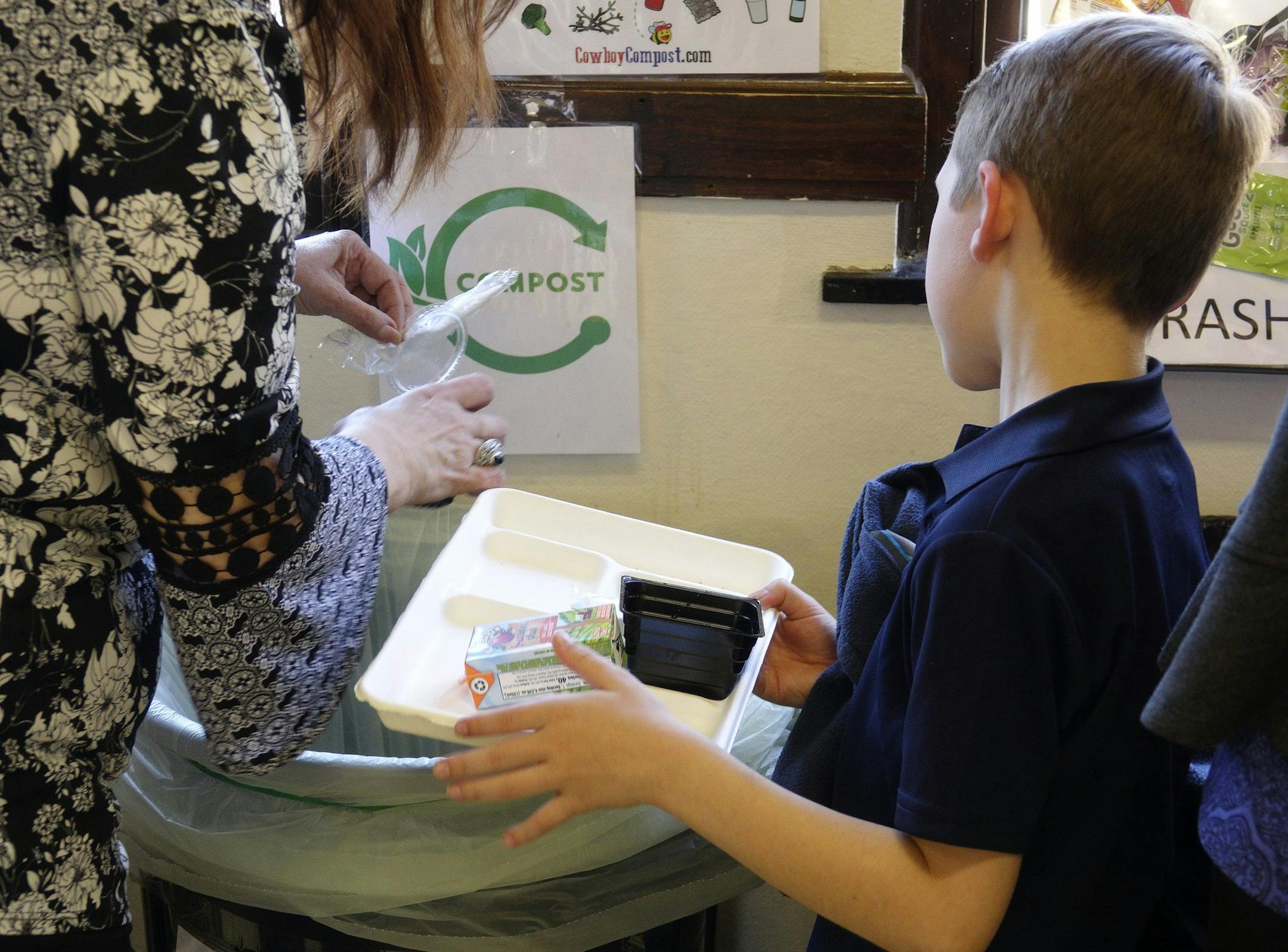 A student prepares to deposit his paper lunch tray into the compost bin, the last stop for anything that isn't trash or recyclable. Students at North Hi Mount Elementary School in Fort Worth implement the Share Table Project along with recycling and other conservation efforts. (David Kent/Fort Worth Star-Telegram/TNS) ORG XMIT: 1288020 ORG XMIT: MIN1903260332234239