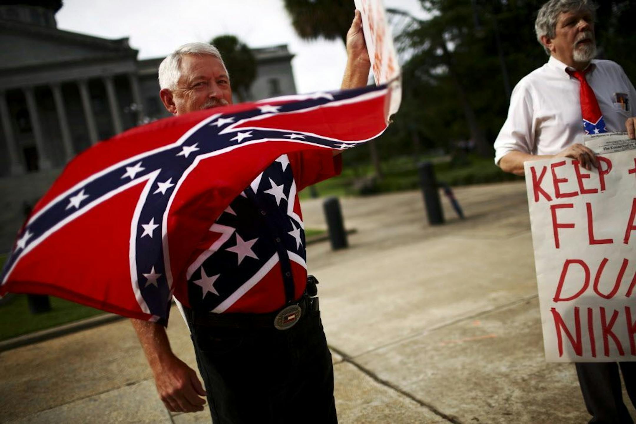 A demonstrator waves a Confederate battle flag outside the South Carolina State House in Columbia, S.C., July 6, 2015. The South Carolina State Senate is scheduled to consider Monday a bipartisan proposal to remove the Confederate battle flag that flies on the State House grounds.