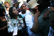 Relatives of Katricia Daniels and Robert Shepard mourned them in front of the house during a vigil Monday night. About 200 people — family members, 