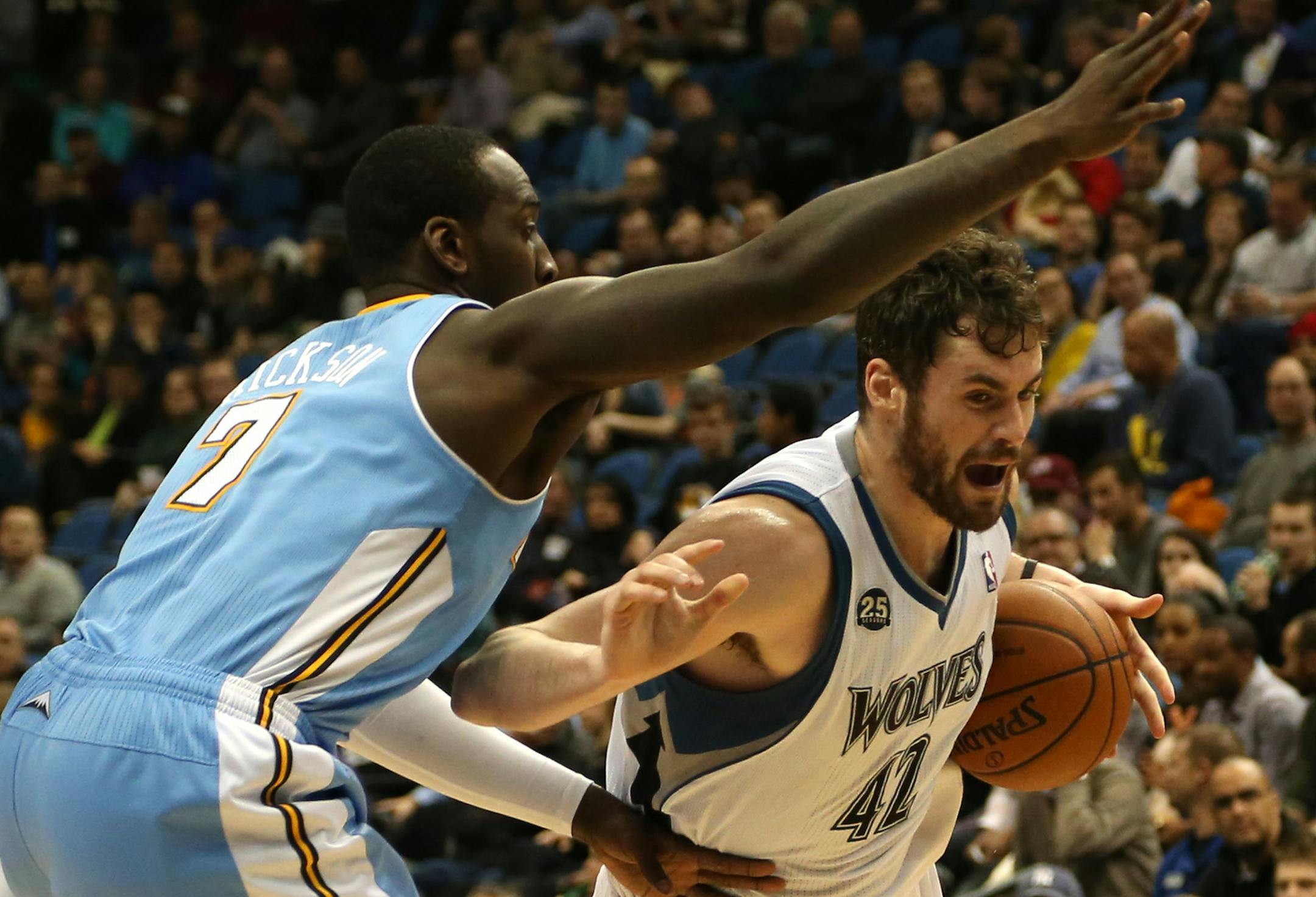 Wolves Kevin Love drove to the basketball with Denver's J.J. Hickson defending during the first half at the Target Center in Minneapolis Wednesday, February 12, 2014. ] (KYNDELL HARKNESS/STAR TRIBUNE) kyndell.harkness@startribune.com