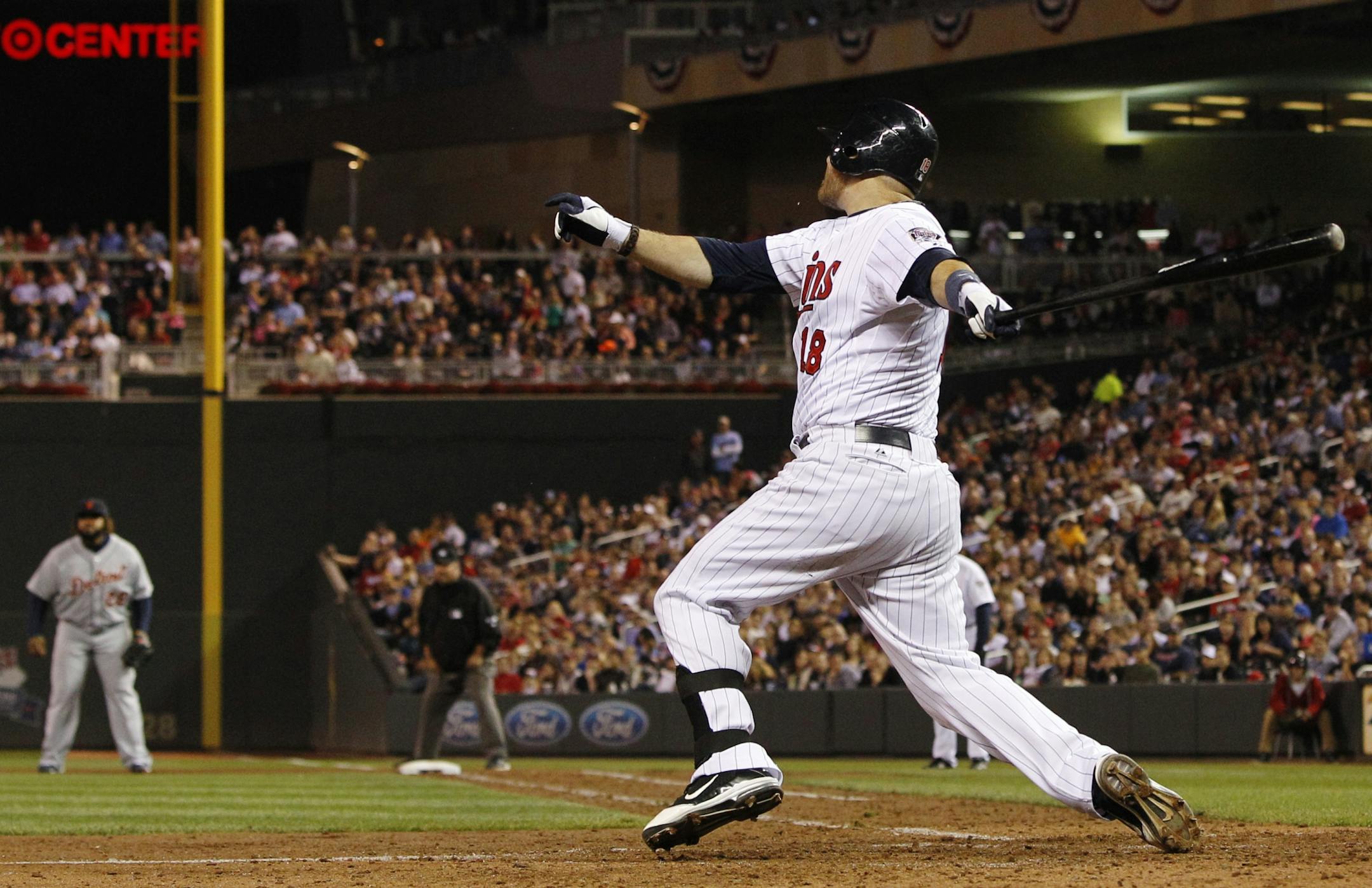 Minnesota Twins designated hitter Ryan Doumit hits a two-run home run against Detroit Tigers relief pitcher Phil Coke during the seventh inning of a baseball game, Friday, Sept. 28, 2012, in Minneapolis.
