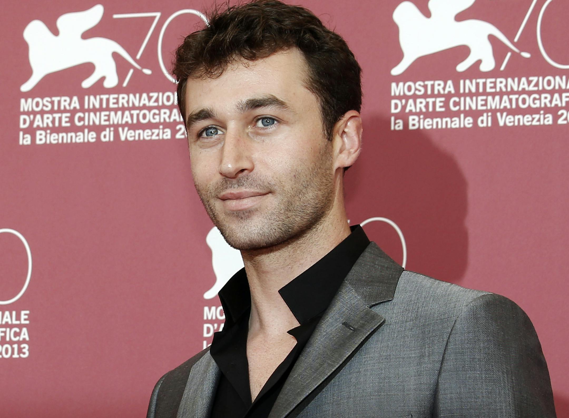 FILE - In this Aug. 30, 2013, file photo, actor James Deen poses for photographers at the photo call for the film The Canyons at the 70th edition of the Venice Film Festival in Venice, Italy. The California watchdog agency tasked with ensuring safety in the workplace said it is investigating porn actor Deen's production company after allegations that the reigning star of adult films sexually assaulted women on and off movie sets. (AP Photo/David Azia, File)