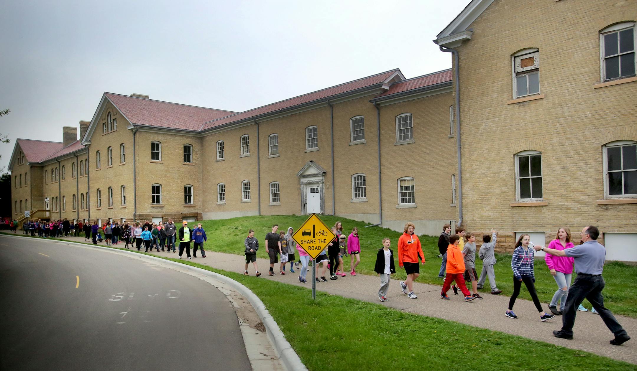 Fort Snelling is now part of a national nonprofitís ìNational Treasuresî campaign and has been dubbed ìBdote Fort Snellingî by the National Trust for Historic Preservation. Here, a tour group of students walks by a group of idle buildings, one of which will house a new Fort Snelling visitor center and was seen Wednesday, April 20, 2016, at Fort Snelling, MN.](DAVID JOLES/STARTRIBUNE)djoles@startribune.com Fort Snelling gets new designation from national nonprofit. Declar