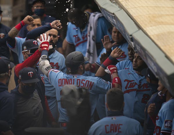 Minnesota Twins third baseman Josh Donaldson (24) was congratulated in the dugout after he hit a solo homer in the fifth inning off Cleveland Indians 