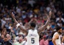 Wolves star Anthony Edwards celebrates at the in the final minute of game of Game 7 of the team's playoff series against the Nuggets in Denver on Sund
