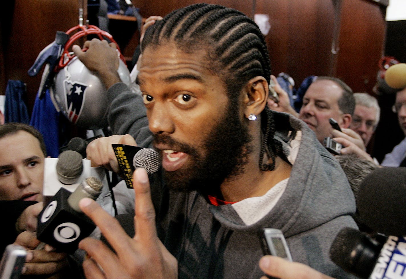 New England Patriots wide receiver Randy Moss answers reporter's questions concerning allegations that he committed battery on a woman he has know for eleven years during a media availability in front of his locker at the NFL football team's facility in Foxborough, Mass., Wednesday morning, Jan. 16, 2008. The Patriots will play the San Diego Charges in the AFC Championship game at Foxborough Sunday afternoon. (AP Photo/Stephan Savoia) ORG XMIT: MASS110