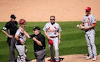 Third base umpire Joe West, center, tosses St. Louis Cardinals manager Mike Shildt (8) after pitcher Giovanny Gallegos was asked to change gloves.