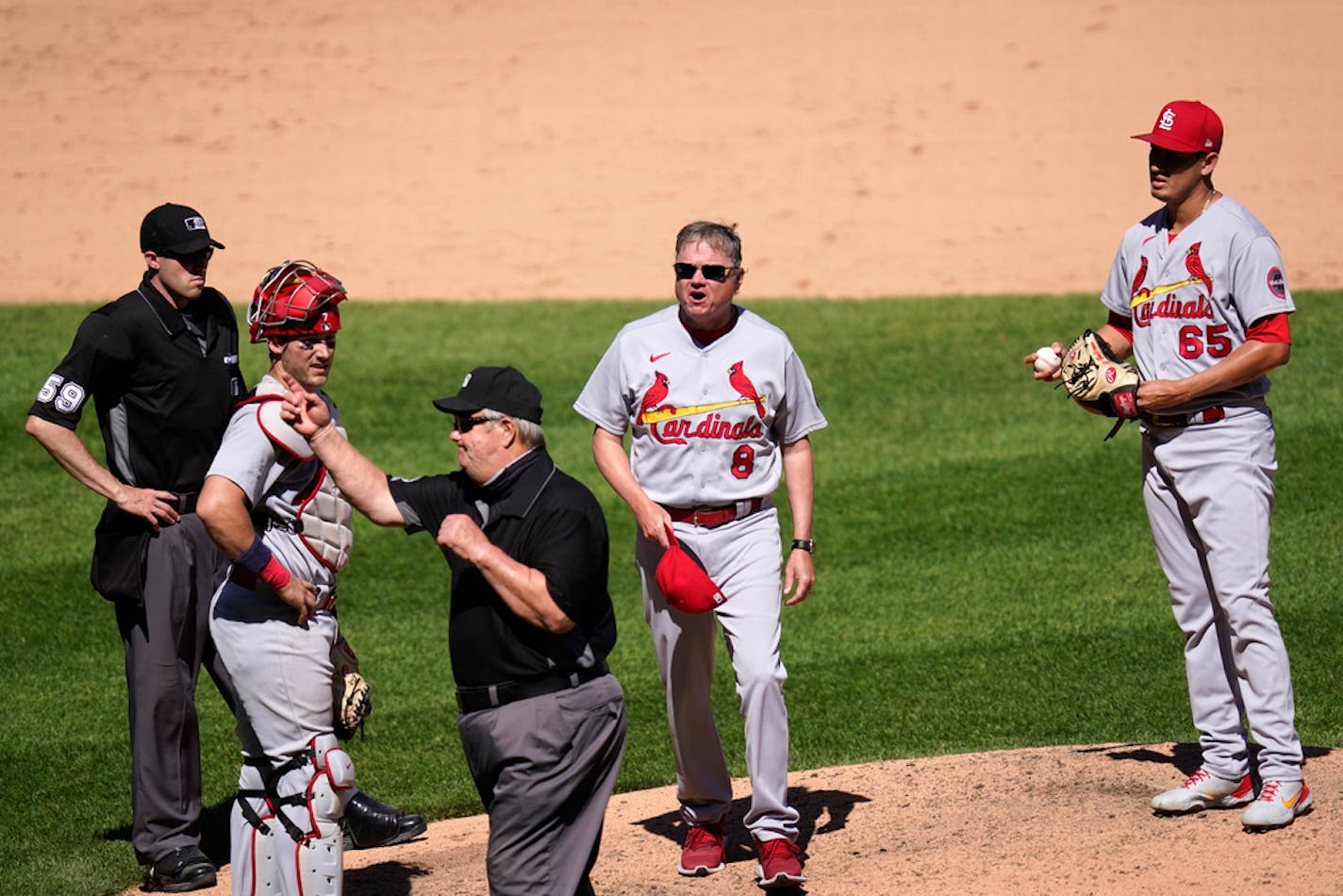 Third base umpire Joe West, center, tosses St. Louis Cardinals manager Mike Shildt (8) after pitcher Giovanny Gallegos was asked to change gloves.