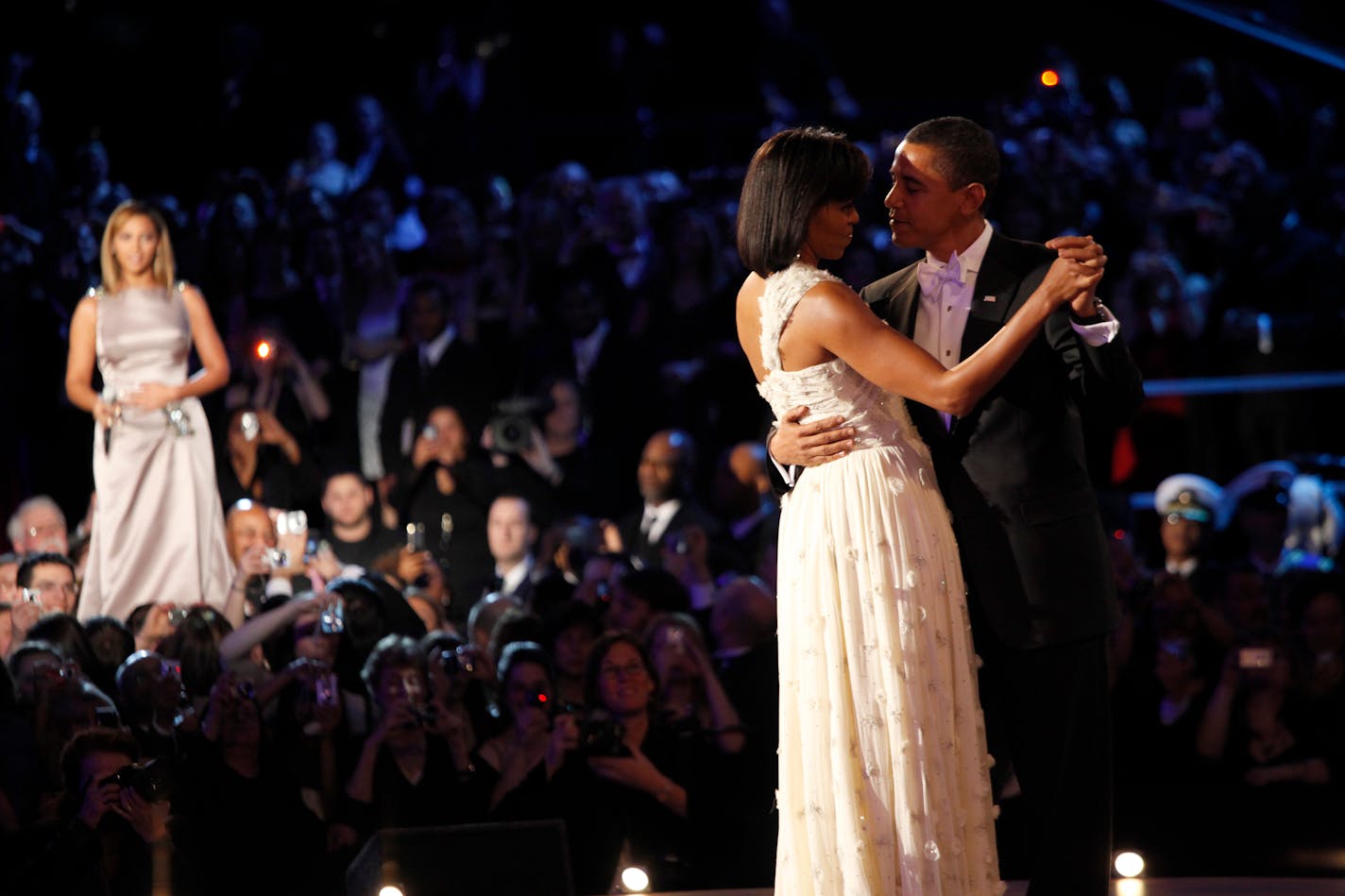 President Barack Obama and first lady Michelle dance as Beyonce, far left, performed for them, during their first dance of the evening at the Neighborhood Inaugural Ball at the Convention Center in Washington, Tuesday, January 20, 2009.