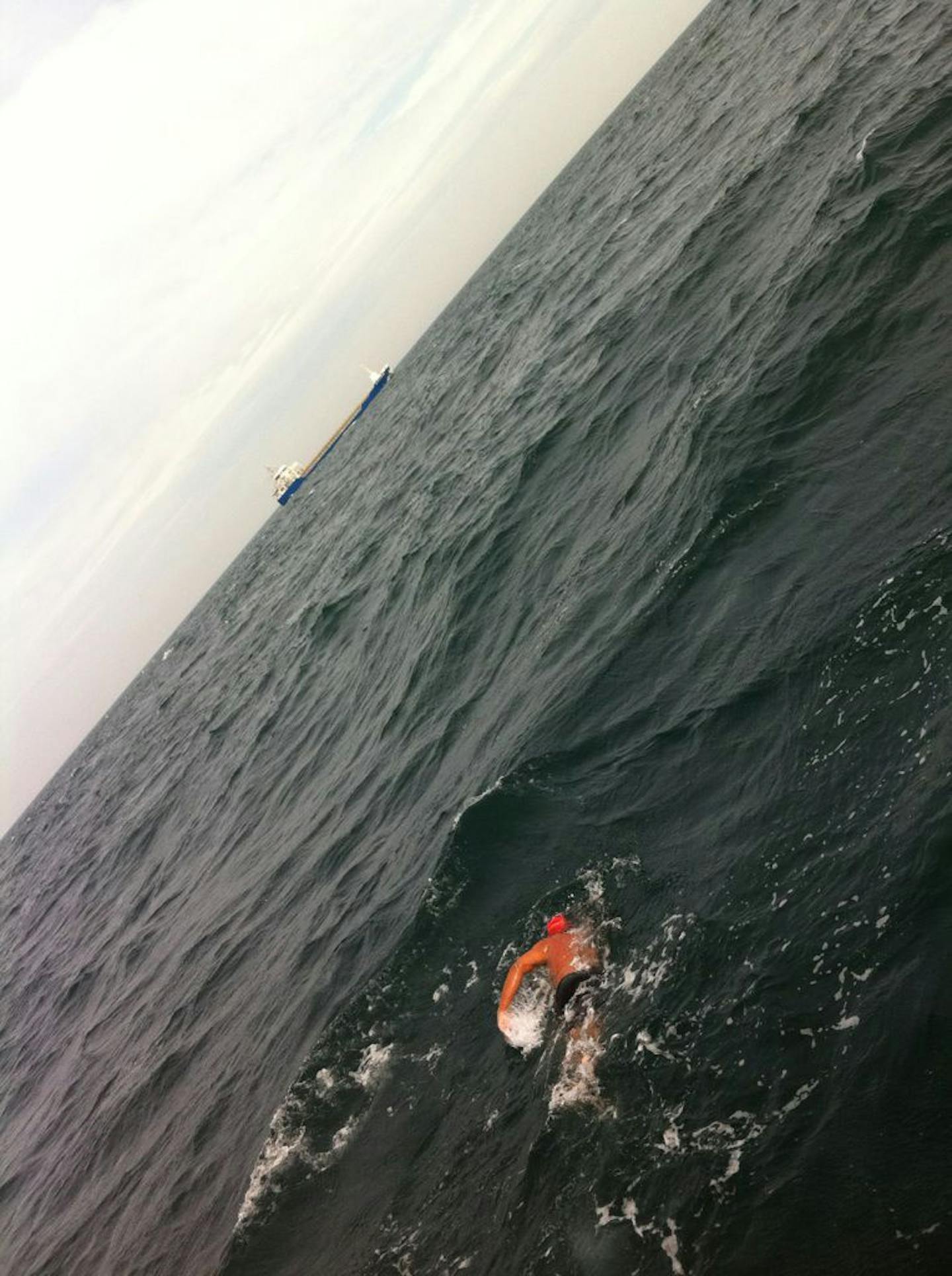 Sailors on the freighter in the background probably didn't see Doug McConnell as he swam from England to France on Sunday.