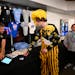 Does this come in a size GOAT? Iowa fan Parker Spindler of Becker, Minn., buys a shirt at a Target Center stand Thursday, the day before star player C