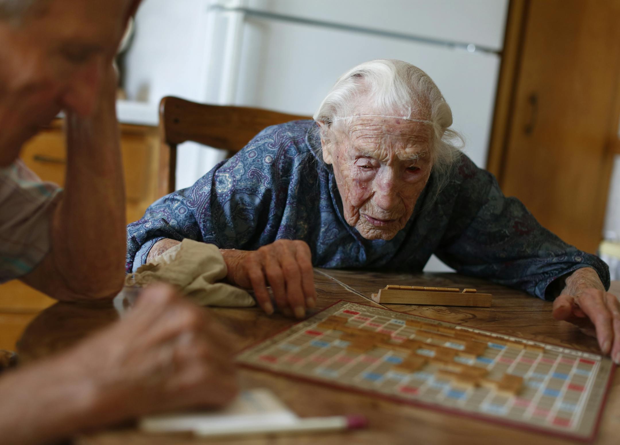 At her home in Pottsdam, Anna Stoehr plays Scrabble with her son Harlan,83 who is changing the hoses on her washer. She is perhaps the oldest person who lives alone. She does not have a special diet but likes to bakes her own bread. She also likes to eat liverwurst, butter, and bacon.] rtsong-taatarii@startribune.com, ORG XMIT: MIN2013060711585937
