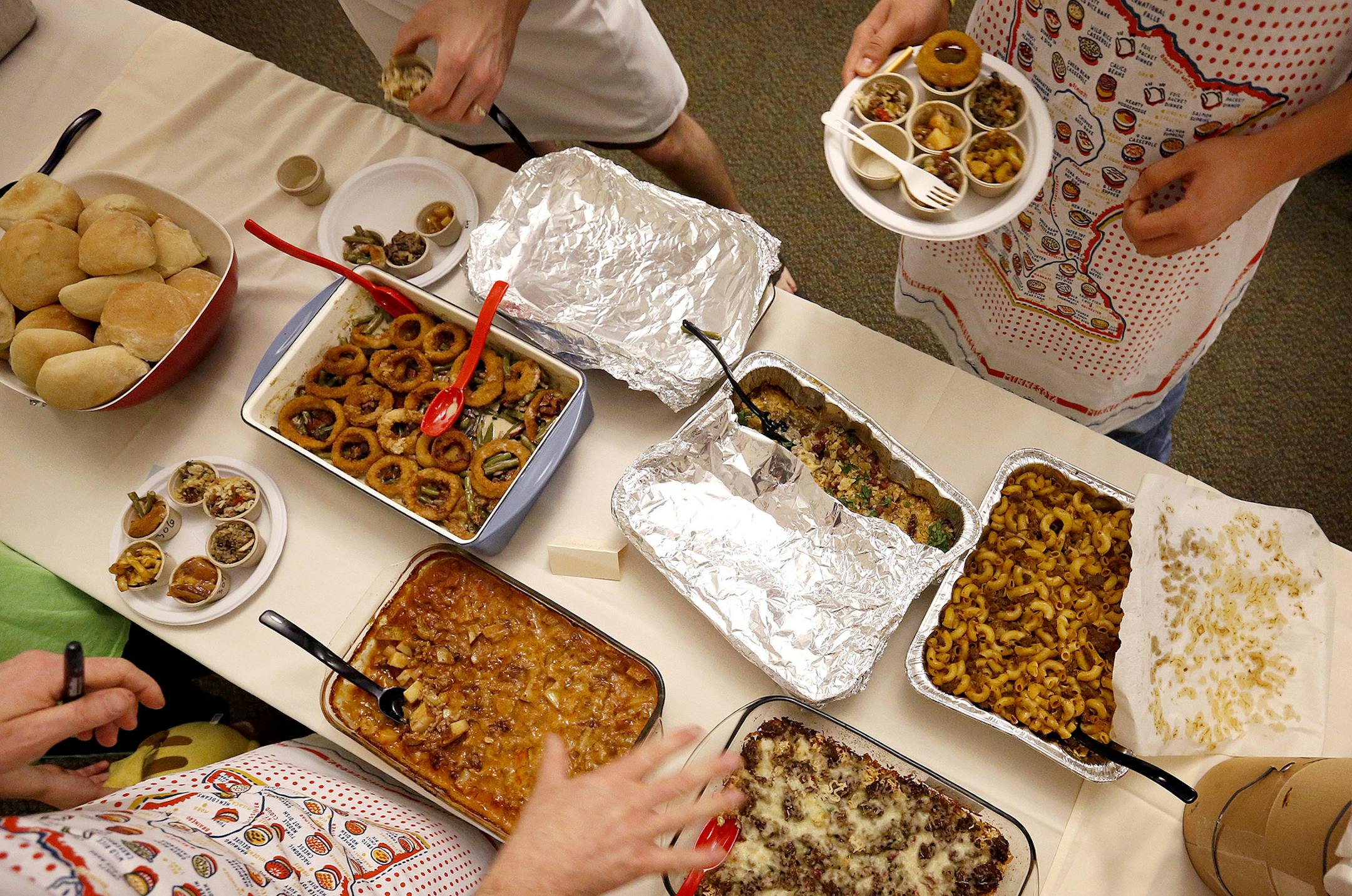 Judges filled up their sample cups at the Holland Neighborhood's 11th Annual Hotdish Revolution at St Maron's Cedars Hall in Northeast Minneapolis. ] CARLOS GONZALEZ cgonzalez@startribune.com, April 12, 2015, Minneapolis, MN, St Maron's Cedars Hall, Holland Neighborhood's 11th Annual Hotdish Revolution, featuring celebrity judges and music, plus entries into hotdish categories: spicy, vegetarian, tater tot excellence, kids, dar good, fins & feathers. There is also a Jello comptition. ORG XMIT: M