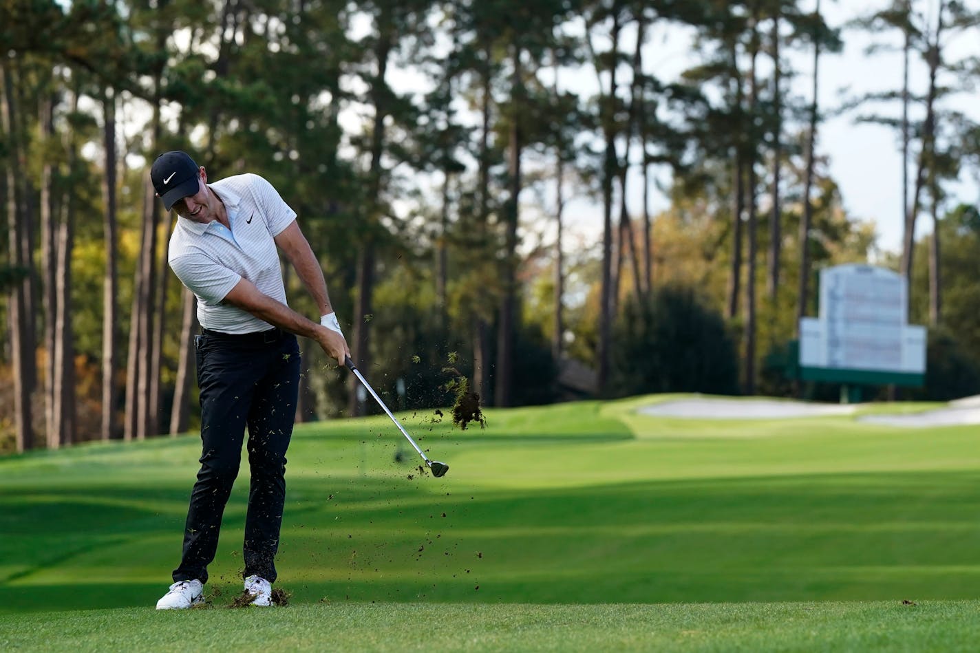 Rory McIlroy chips to the second green during the first round of the Masters