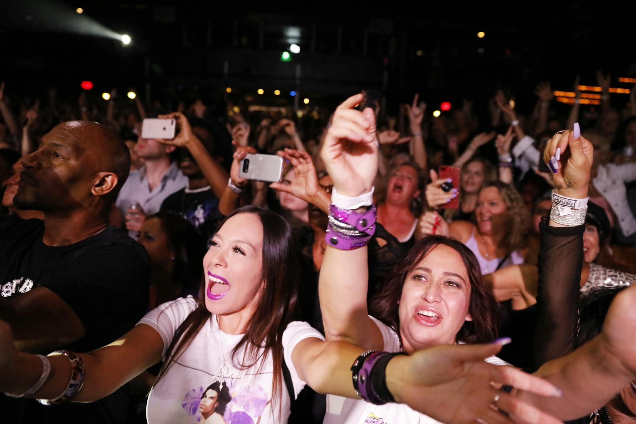 Fans sing along during the New Power Generation show.