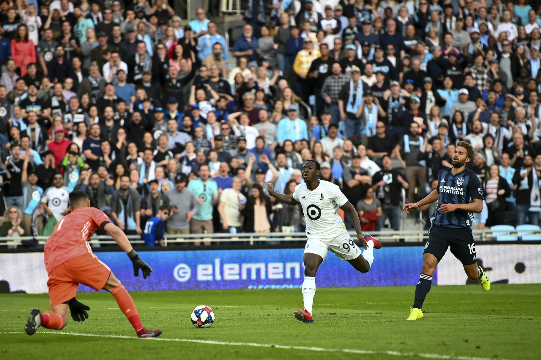 Minnesota United forward Abu Danladi (99) let the ball get too far in front of him into the hands of Los Angeles Galaxy goalkeeper David Bingham (1) in the first half as Los Angeles Galaxy defender Jorgen Skjelvik (16) chased from behind.
