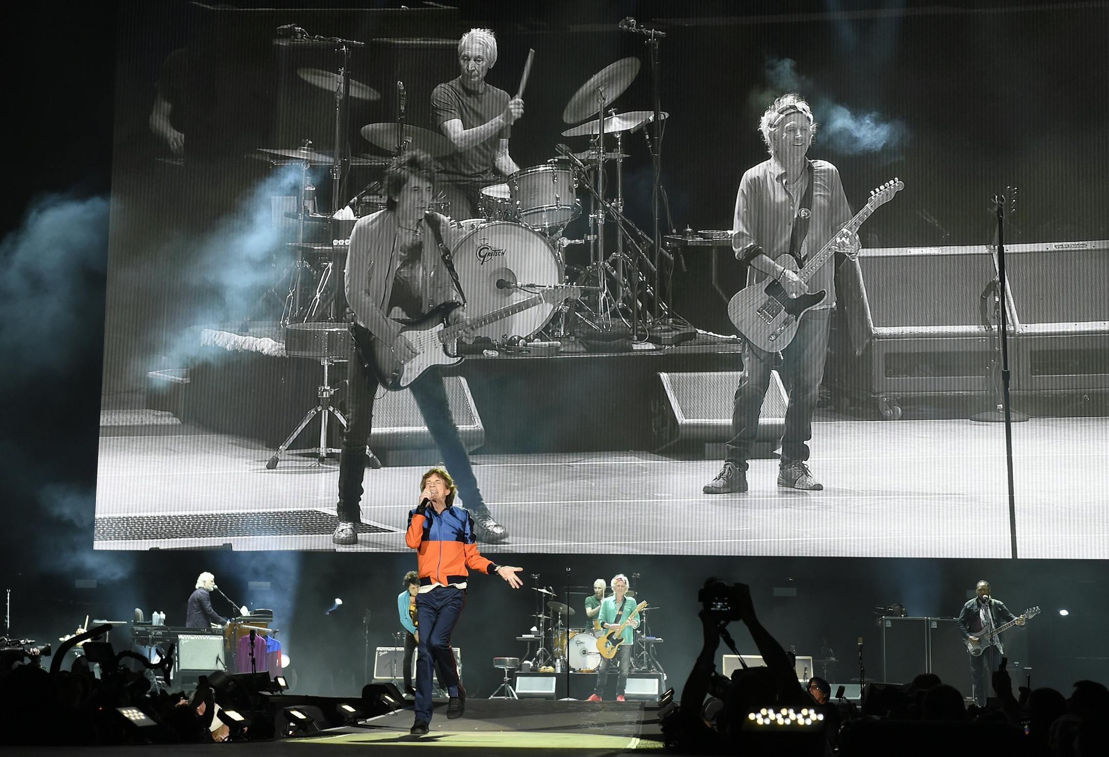 Mick Jagger of The Rolling Stones performs in front of a video monitor showing band mates, from left, Ron Wood, Charlie Watts and Keith Richards on day 1 of the 2016 Desert Trip music festival at Empire Polo Field on Friday, Oct. 7, 2016, in Indio, Calif.