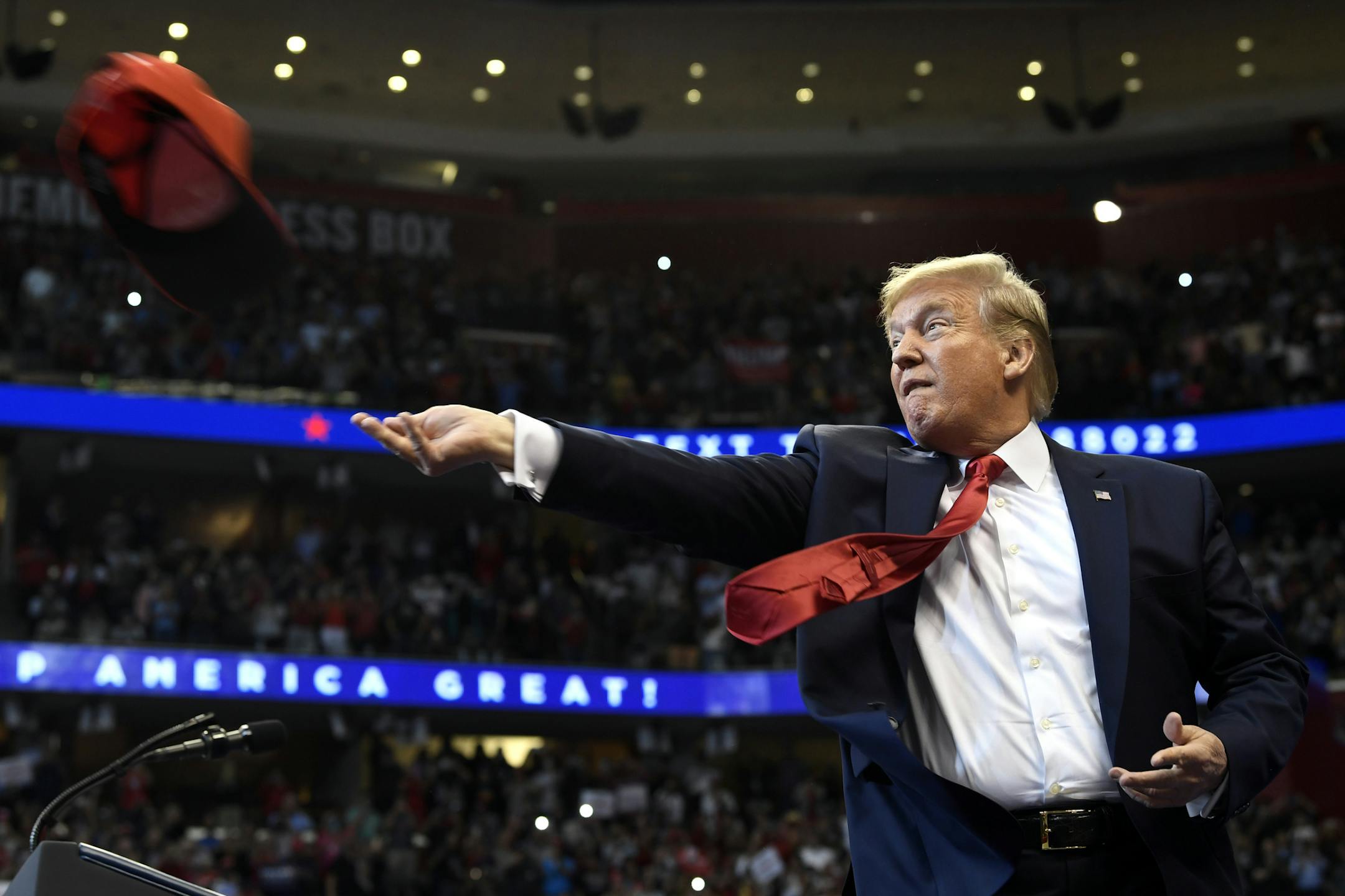 President Donald Trump throws a hat as he arrives to speak at a campaign rally in Sunrise, Fla., Tuesday, Nov. 26, 2019. Trump will join the rest of his family and spend the Thanksgiving holiday at his Mar-a-Lago estate. (AP Photo/Susan Walsh)