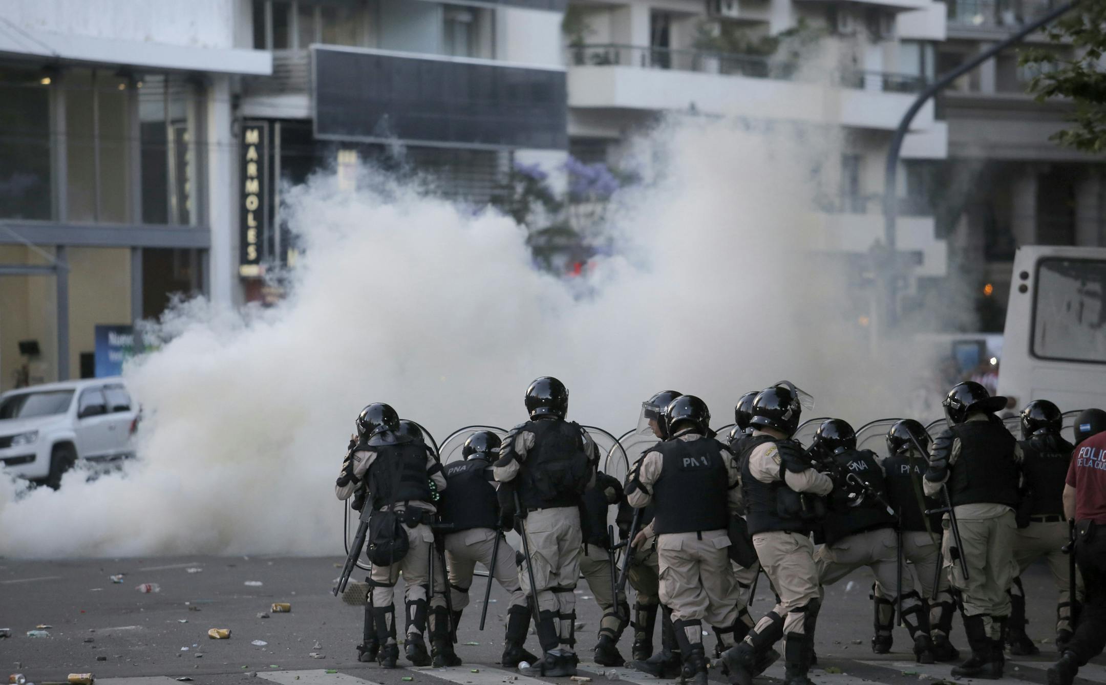 Argentina River Plate fans clash with riot police outside the Antonio Vespucio Liberti stadium prior the final soccer match of the Copa Libertadores