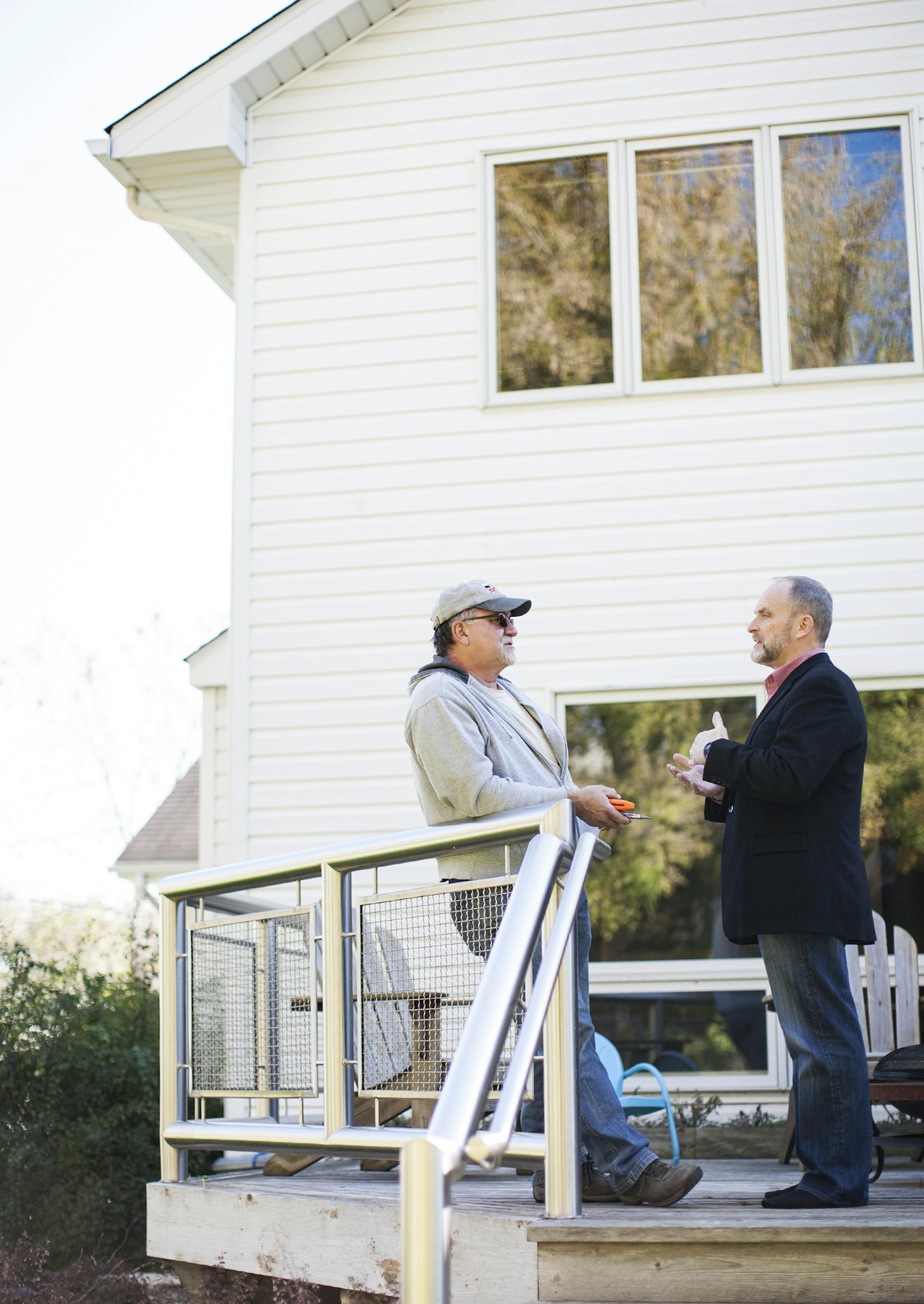 Realtor Greg Anderson, right, talks with home owner Don Mohs about his house which has been on the market for over a month in Chaska October 11, 2014. (Courtney Perry/Special to the Star Tribune)