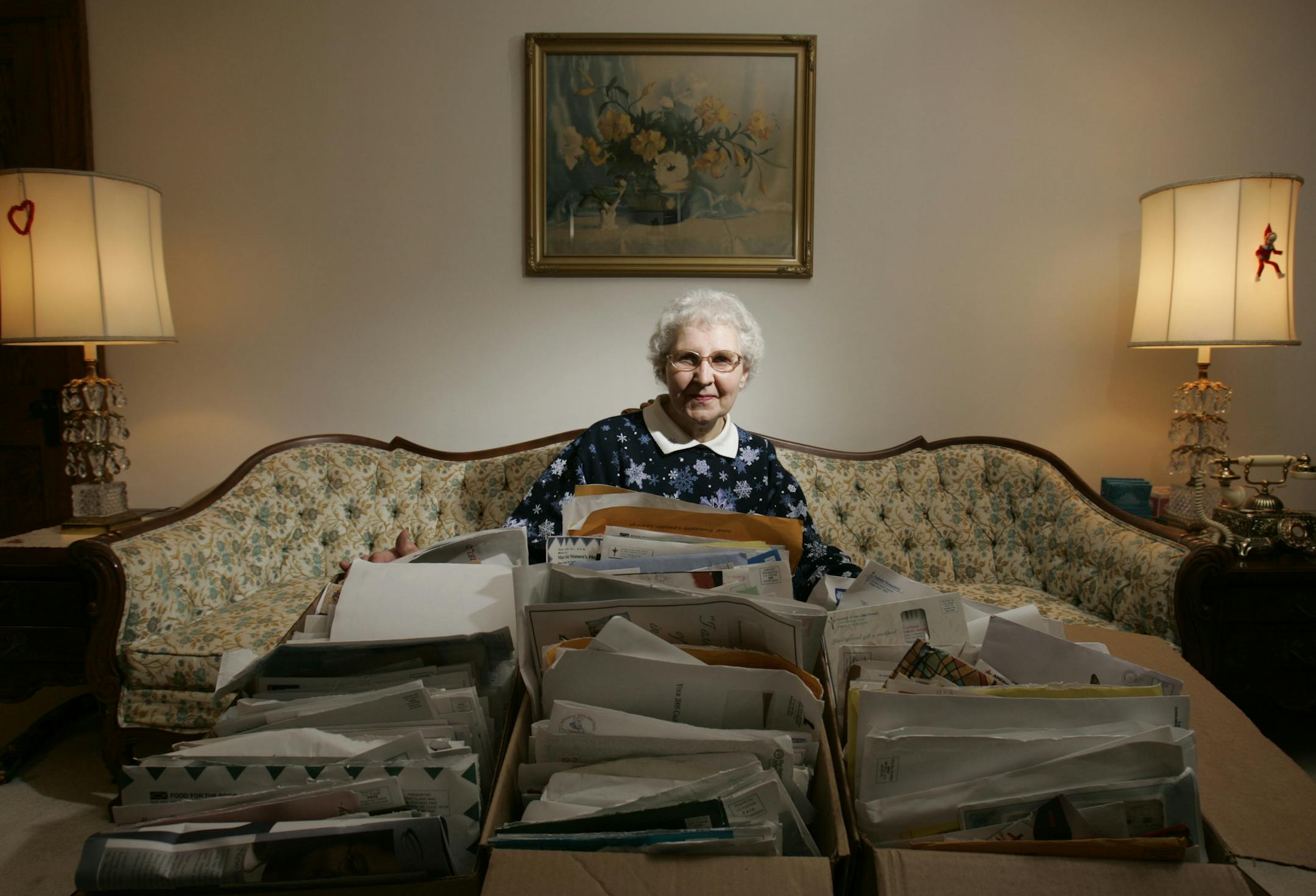 Staff photo/Jeff Wheeler CHARxx: In the world of charity, it«s clear that one thing leads to another. Donna Stelmaszewski of northeast Minneapolisgives to about 20 organizations. But, because so many charities share solicitation lists, she got new requests with almost every mail deliver. She kept them all--three boxes full, perhaps 800 to 1,000 of them. Photo shows Donna in her home with her solicitation mail. ORG XMIT: MIN2013060715134258