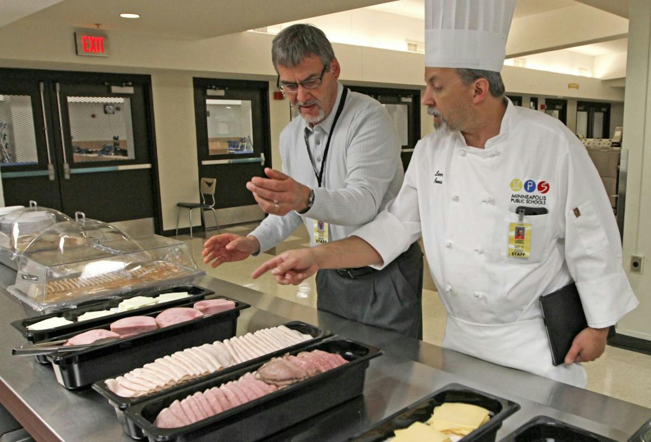 Minneapolis School District nutrition director Bertrand Weber, left, and Washburn High School chef Larry Jones set up the fresh sandwich bar Thursday.