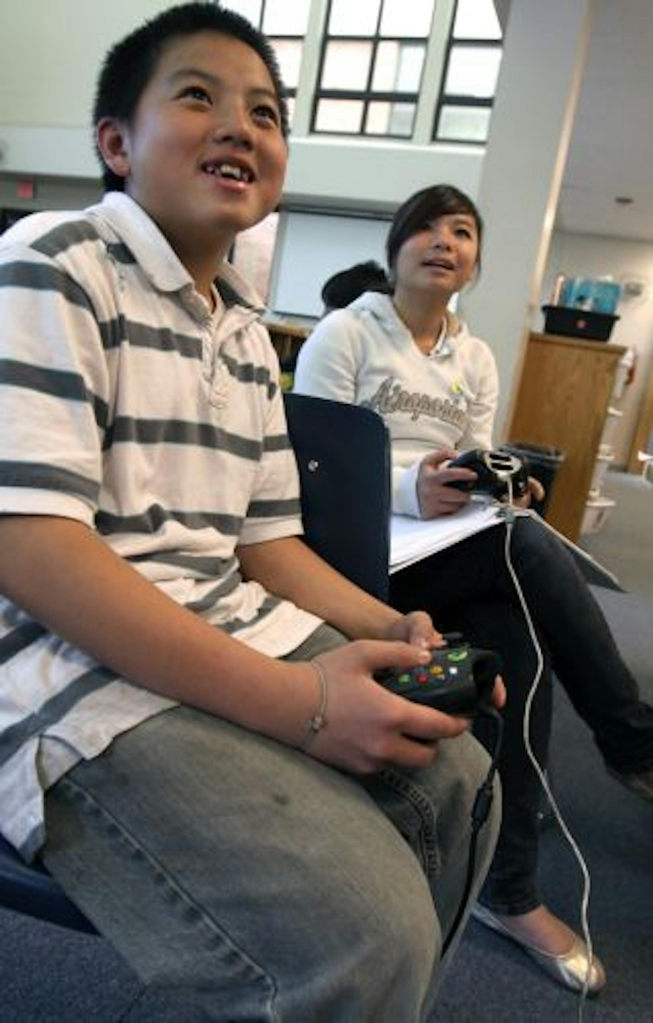 Seward Montessori School students Chee Hang and Pachia Lee played a XBox Karaoke Revolution game during Brock Dubbels class that uses video games as a learning tool.