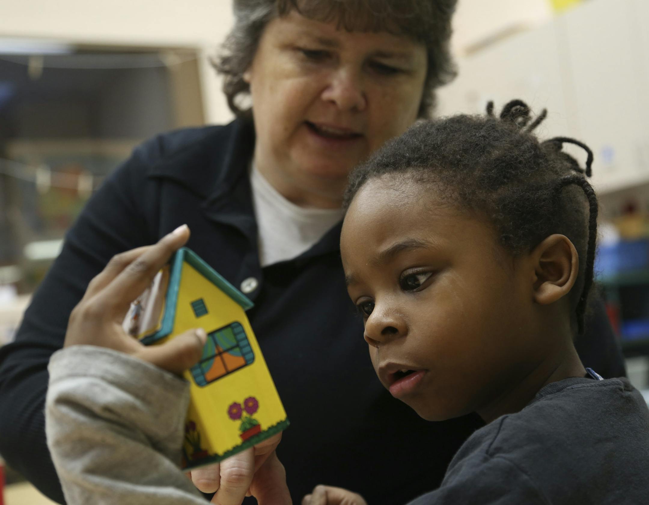 Jamar Morgan,4, took a closer look at one of the rhyming houses he and his teacher Laurie Ostertag were using at Family Partnership Child Care Center in Minneapolis , Min.,Wednesday, March 6, 2013. ] (KYNDELL HARKNESS/STAR TRIBUNE) kyndell.harkness@startribune.com