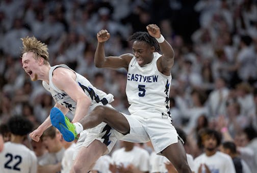 Eastview's Chet Kloss, left, and Elias Batala celebrate their 72-68 win over Minnetonka.