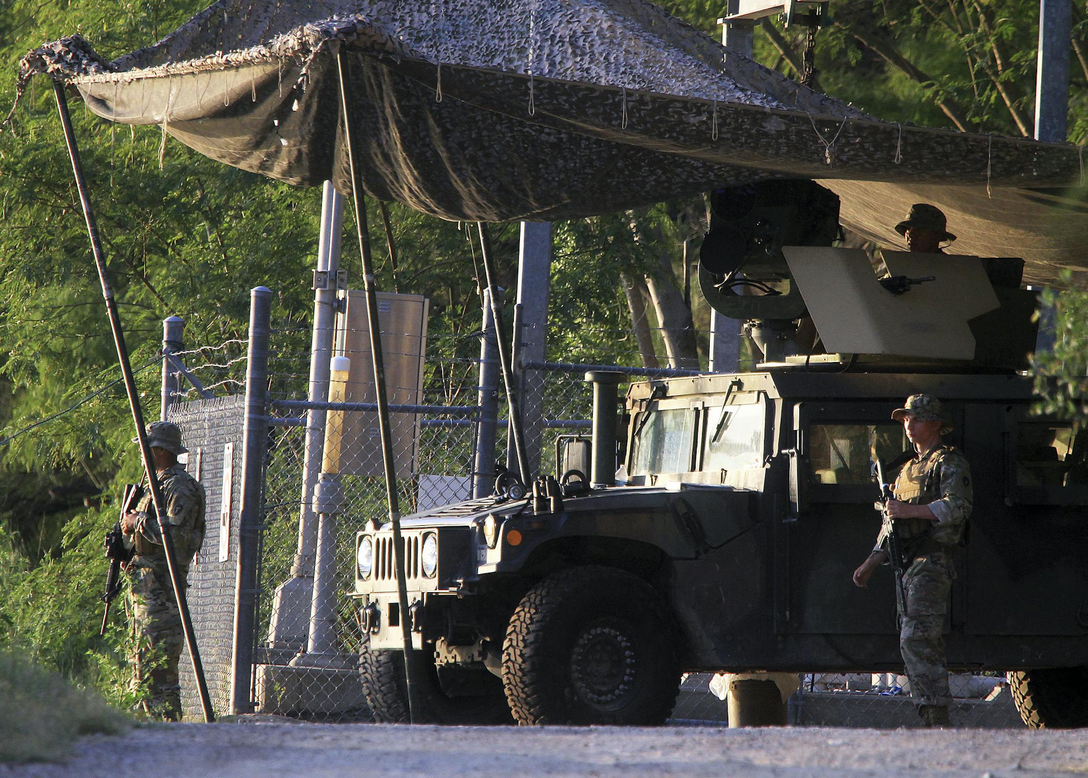 Solders from the Texas Army National Guard keep watch on the banks of the Rio Grande on Wednesday, April 11, 2018, in Roma, Texas. (Joel Martinez/The Monitor via AP)