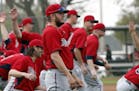 In this Feb. 24, 2015 photo, Twins closer Glen Perkins (front) stretched with teammates at the start of a baseball spring training workout in Fort Mye