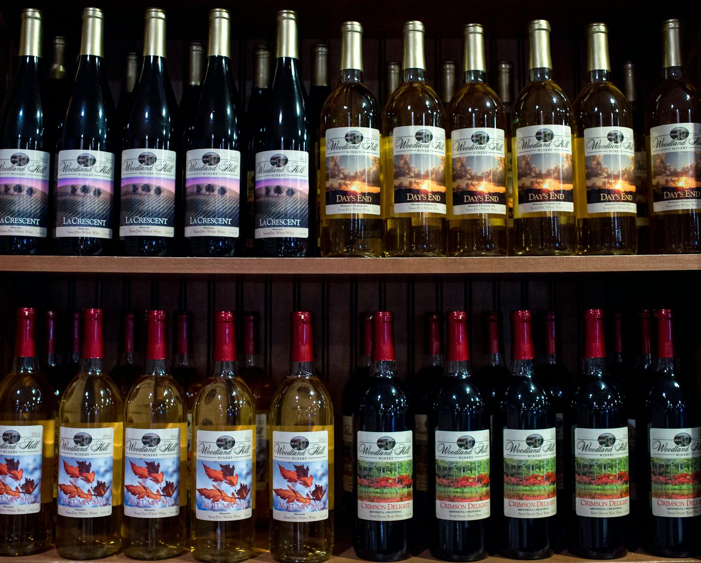 Woodland Hill Winery's bottles are displayed behind the bar.